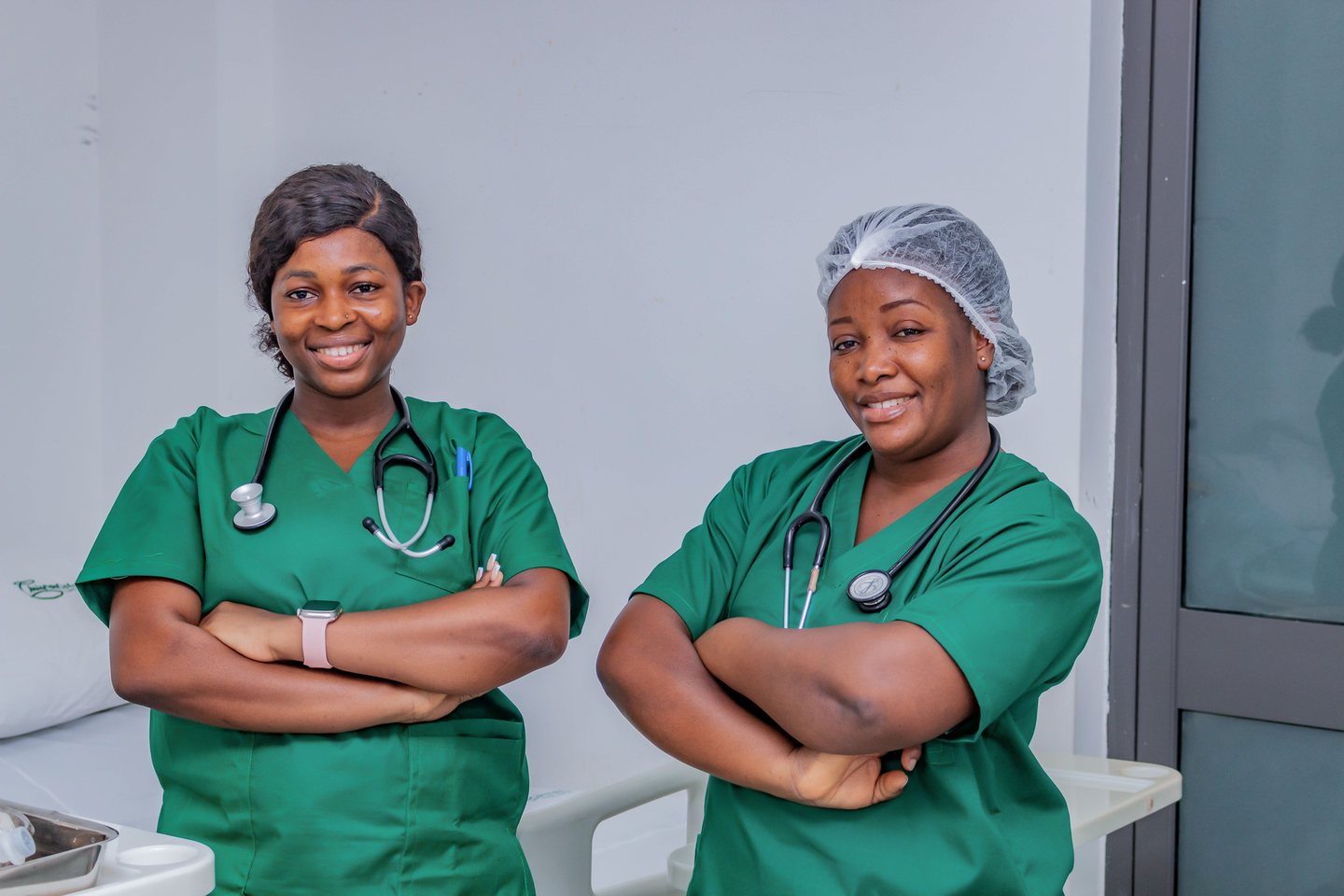 Two nurses standing confidently in a healthcare setting